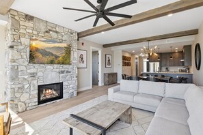 Spacious Living Room - Spacious and Scenic Living Room with Stone Fireplace, Floor to Ceiling Windows with Smoky Mountain View, Smart TV's and WiFi throughout vacation condo