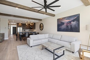 Gatlinburg Vacation 3 Bedroom Condo Rental with Pool and Mountai - Spacious and Scenic Living Room with Stone Fireplace, Floor to Ceiling Windows with Smoky Mountain View, Smart TV's and WiFi throughout vacation condo