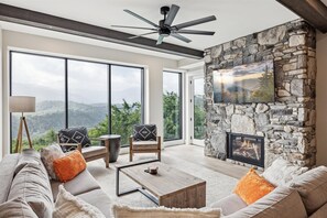 3 Bedroom Gatlinburg Vacation Condo Rental Highlands Condos of t - Spacious and Scenic Living Room with Stone Fireplace, Floor to Ceiling Windows with Smoky Mountain View, Smart TV's and WiFi throughout vacation condo
