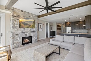 Spacious Living Room - Spacious and Scenic Living Room with Stone Fireplace, Floor to Ceiling Windows with Smoky Mountain View, Smart TV's and WiFi throughout vacation condo