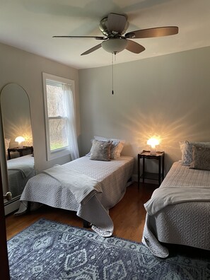 Whimsical twin bedroom is great for children or friends.