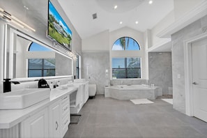 Luxe ensuite bathroom in primary suite #1 - smart TV, large vanity, jacuzzi tub