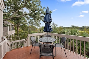 The front porch has views of the golf course and marsh