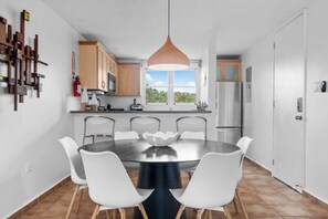 The 6-person dining table and fully equipped kitchen.