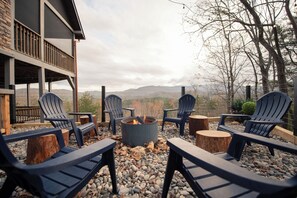 The fire pit is tucked on the side of the cabin, perfect for gazing at the view!