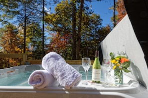 Hot tub on the deck, complete with soft towels and a bottle of wine for the perfect touch of luxury