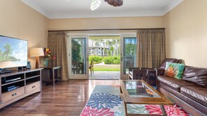 Inviting and spacious living room with cozy couches and entertainment set.