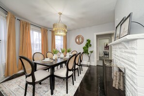 Dining area with 8 plush seats and a fireplace