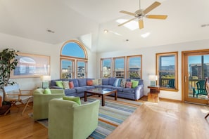 Top-Level Living Area with floor-to-ceiling windows and plenty of open space.