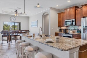 Bright, open, fully-equipped kitchen. Kitchen island seats 4