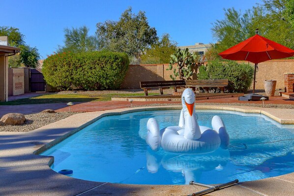 Large private yard with private pool, multiple lounge areas, lanai with outside dining area, fire pit, and BBQ.