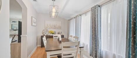 Just off the living area is the beautiful dining room with wall length windows