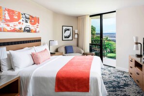 Primary bedroom features a king bed, door to private balcony, and ensuite bathroom.