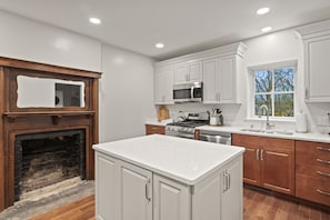 Unit #1 (1 of 3,  Ground Floor) Cook up a feast in this modern kitchen featuring stainless steel appliances and a spacious island. 🍽️👨‍🍳✨