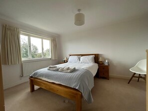 Bedroom 1 with kingsize bed, en-suite bathroom and sea views