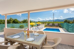 Outdoor sheltered terrace with dining area