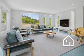 Main living area includes a wood fireplace (a starter kit is provided May-Aug)