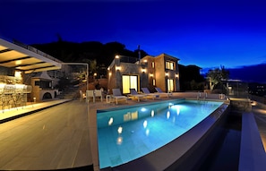 Outdoor private pool area with barbeque, offering amazing sea views