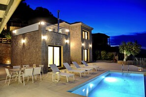 Outdoor private pool area with barbeque, offering amazing sea views