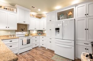 A fully stocked kitchen awaits, equipped with all you need and Keurig coffee pods for that perfect brew