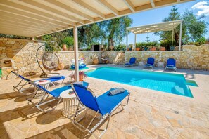 Shaded pool terrace and sparkling pool