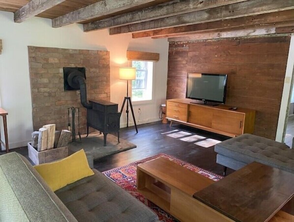 Living room features a wood burning stove and TV with Amazon Firestick.