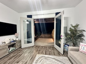 Living room view looking out to pool & hot tub.