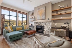 Electric fireplace, comfortable sofas and TV in the living room for cozy evenings