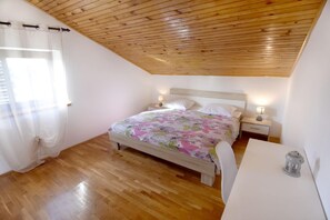 The bedroom with double bed, desk and bedside tables with night lamps