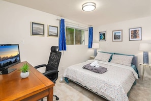 Here is the 1st bedroom with a queen size bed and a big office desk.