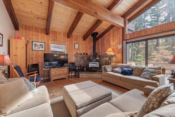 Open living room / dining area / kitchen opening up to back deck.