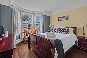 Serene queen bedroom with a picturesque power street view. 😌🛏️