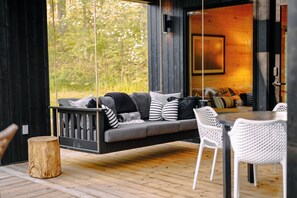 Eat & Play features a covered Patio with ceiling fan. and hanging day bed