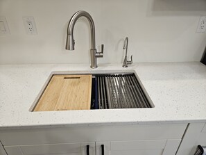 Farm house  sink with built-in cutting board and dish draining rack