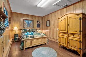 Spacious Queen Bedroom with walkout to front drive area.