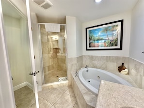 Indulge in a spa day - every day- with our luxurious bathtub and spacious shower—true relaxation awaits. #NaplesLuxury #SpaLikeBathroom #RelaxInStyle