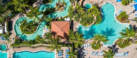 Dive into our lagoon-style pools, where the water is as warm as the welcome. #AerialOasis #LagoonPool #NaplesResort #VacationDream #FloridaEscape