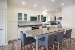 The kitchen opens directly into the main area of the home.  Enjoy modern appliances and bar seating for an additional 4 people. 