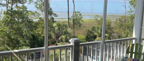 Screened porch with view of bay.  Enjoy the water even when your feet are dry.