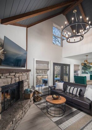Main level great room. Gas logs being added mid December 2023. Firewood provided in the interim. Large 55" smart TV with multiple streaming apps. Family games provided in cabinet under the stairs.