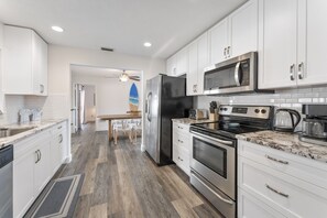 Cook with ease in a modern kitchen featuring sleek stainless steel appliances for a seamless culinary experience
