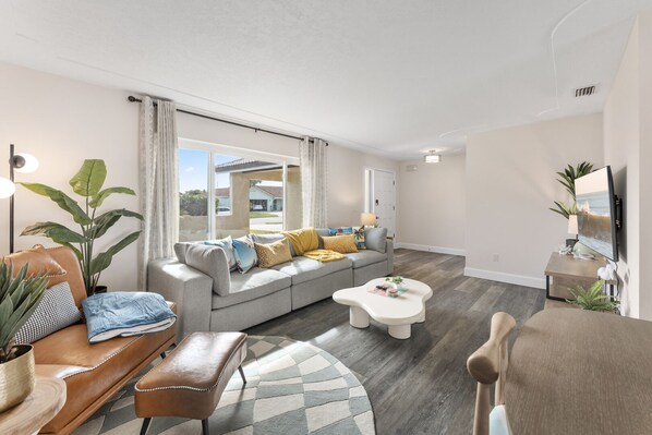 Enjoy an open dining and living area with a modern Scandinavian vibe, featuring clean lines, cozy textures, and a bright, airy feel.
