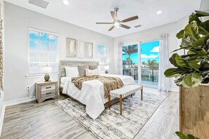 Drift off in this serene bedroom with a plush bed, warm tones, and private balcony access.