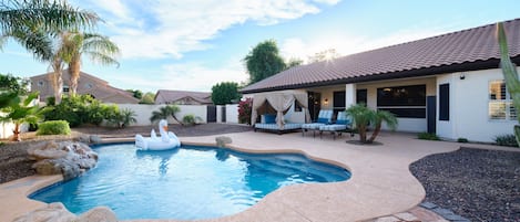 Backyard featuring pool, hot tub, bbq grill, outdoor cabana bed, sun loungers, and outside dining area.