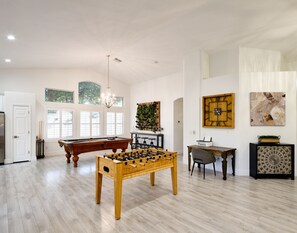 Open concept living area with foosball, pool table, and work station.