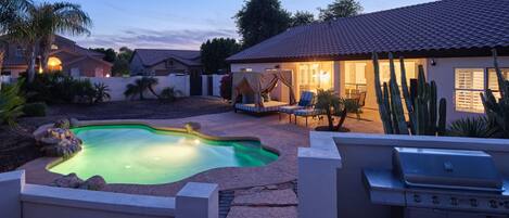 Backyard featuring pool, hot tub, bbq grill, outdoor cabana bed, sun loungers, and outside dining area.