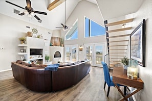 Step into this inviting living room with natural lighting and a breezy ceiling fan