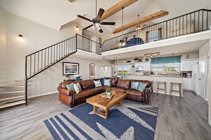 Hardwood floors and a classic staircase make this living room the perfect spot for family gatherings  