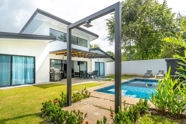 Elegant home featuring a pool and vibrant outdoor space.
