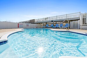 private heated pool with putting green, pool side half bath and refrigerator